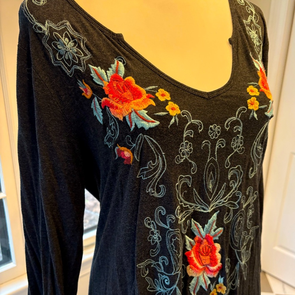 Charcoal grey tunic with pink, yellow, and turquoise floral embroidery.